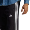 Spodnie męskie adidas Essentials French Terry Tapered Cuff 3-Stripes czarne HA4337