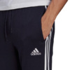 Spodnie męskie adidas Essentials Fleece Tapered Cuff 3-Band Pants granatowe GK8823